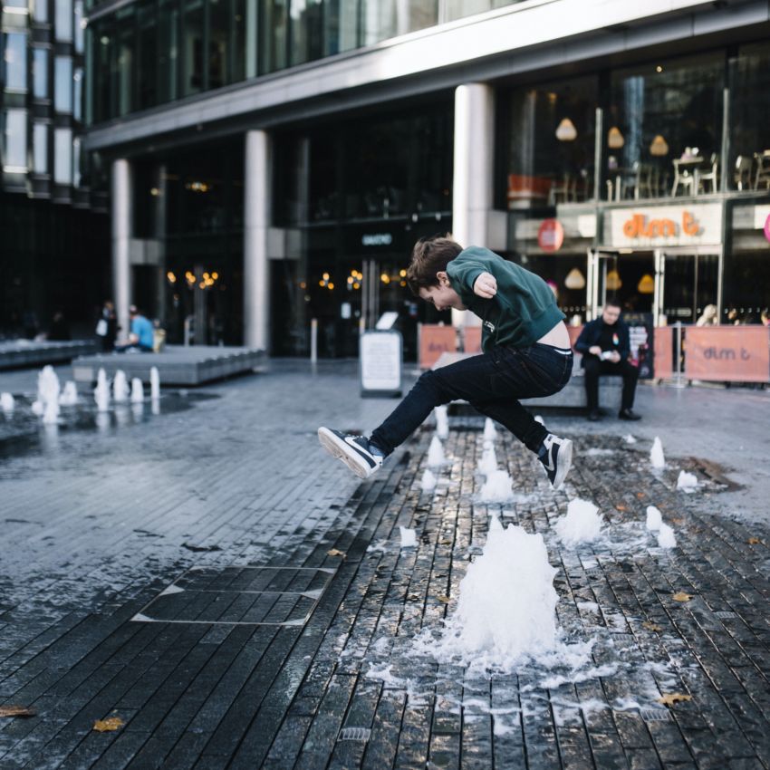 Child Jumping over Fountain at More London